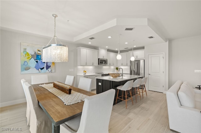 2647 Seychelles Cir Unit 2203, Naples, FL 34112 - dining space featuring baseboards, light wood-style floors, a chandelier, and recessed lighting