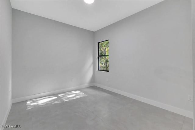 3366 72nd Ave NE, Naples, FL 34120 - empty room with baseboards and concrete floors
