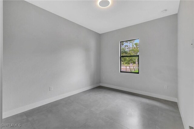 3366 72nd Ave NE, Naples, FL 34120 - unfurnished room with concrete flooring and baseboards