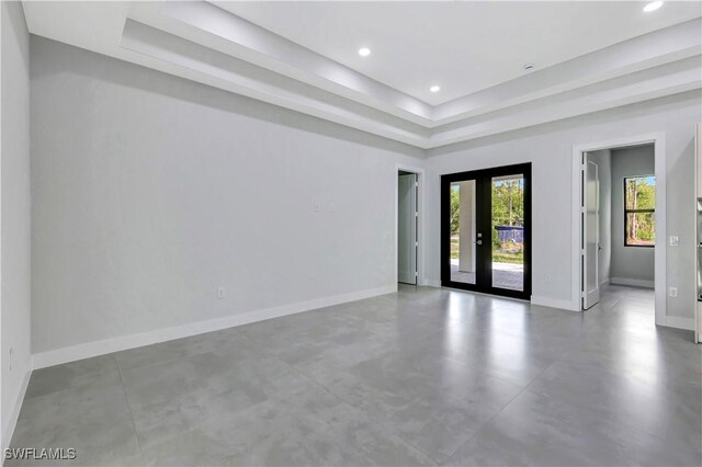 3366 72nd Ave NE, Naples, FL 34120 - unfurnished room with a tray ceiling, baseboards, finished concrete flooring, and recessed lighting