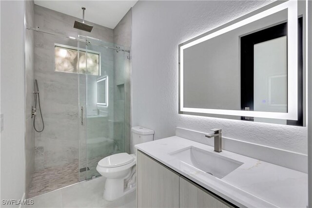 3366 72nd Ave NE, Naples, FL 34120 - full bath with a stall shower, toilet, vanity, tile patterned flooring, and a textured wall