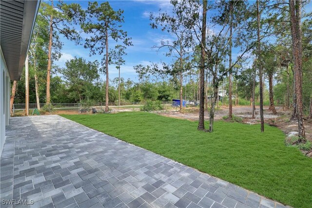 3366 72nd Ave NE, Naples, FL 34120 - view of grassy yard featuring a patio and view of scattered trees