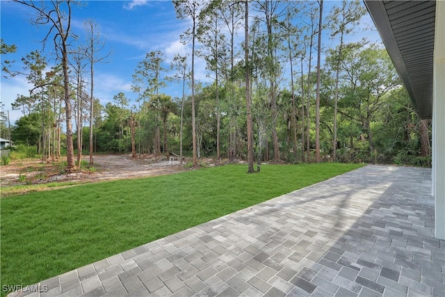 3366 72nd Ave NE, Naples, FL 34120 - view of grassy yard featuring a patio