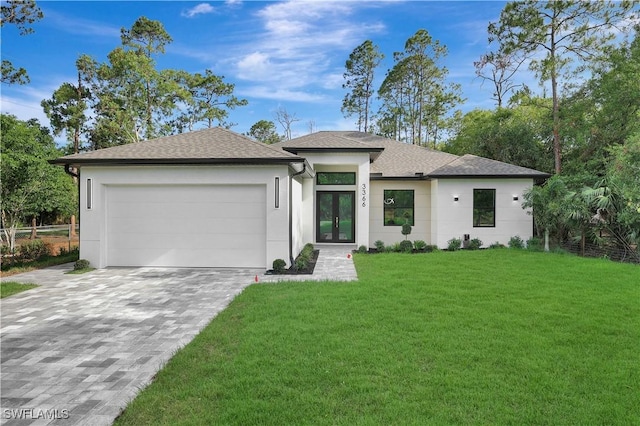 3366 72nd Ave NE, Naples, FL 34120 - view of front of home with french doors, decorative driveway, a garage, a front lawn, and a shingled roof