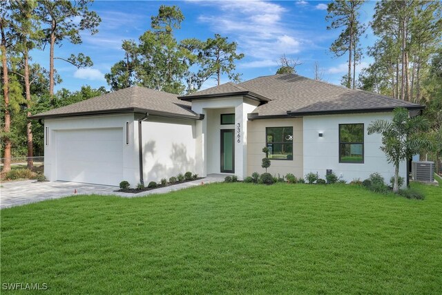3366 72nd Ave NE, Naples, FL 34120 - view of front of house featuring a shingled roof, an attached garage, a front yard, and stucco siding