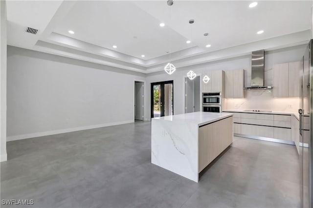 3366 72nd Ave NE, Naples, FL 34120 - kitchen with wall chimney exhaust hood, modern cabinets, double oven, finished concrete flooring, and a kitchen island