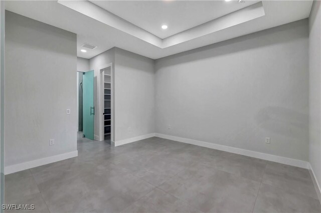3366 72nd Ave NE, Naples, FL 34120 - spare room with baseboards, finished concrete floors, a raised ceiling, and recessed lighting