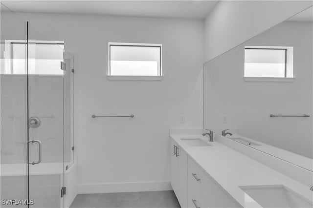 1005 State Ave, Lehigh Acres, FL 33972 - bathroom with plenty of natural light, double vanity, a stall shower, and tile patterned flooring
