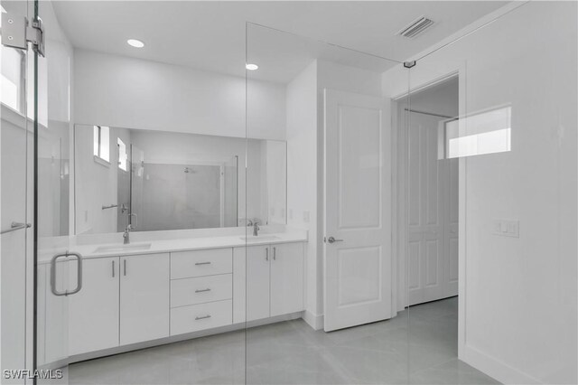 1005 State Ave, Lehigh Acres, FL 33972 - bathroom featuring a stall shower, double vanity, tile patterned floors, and recessed lighting