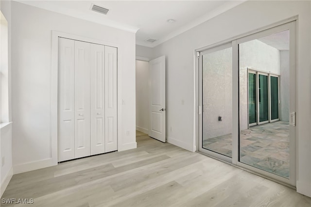 3390 12th Ave SE, Naples, FL 34117 - unfurnished bedroom featuring wood finished floors, baseboards, and ornamental molding