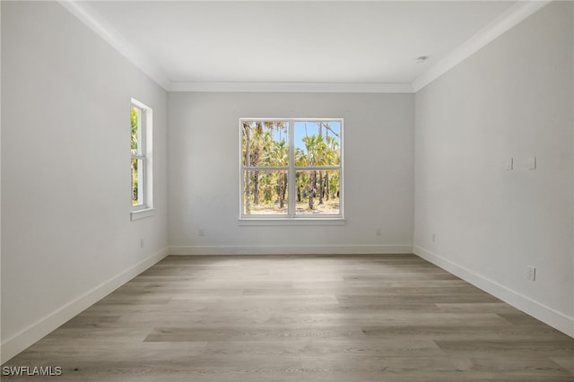 3390 12th Ave SE, Naples, FL 34117 - unfurnished room with healthy amount of natural light, baseboards, light wood-type flooring, and ornamental molding