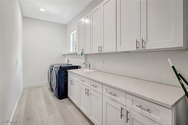 3390 12th Ave SE, Naples, FL 34117 - washroom featuring cabinet space, washing machine and clothes dryer, light wood-style flooring, baseboards, and recessed lighting
