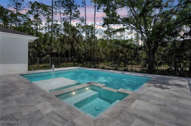 3390 12th Ave SE, Naples, FL 34117 - view of swimming pool featuring a pool with connected hot tub, fence, and a patio area
