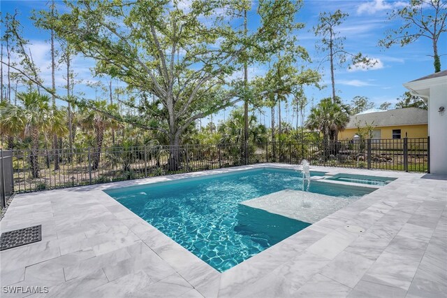 3390 12th Ave SE, Naples, FL 34117 - view of swimming pool featuring fence, a pool with connected hot tub, and a patio