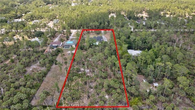 3390 12th Ave SE, Naples, FL 34117 - aerial overview of property's location with a forest and property parcel outlined