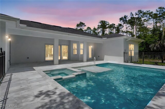 3390 12th Ave SE, Naples, FL 34117 - view of swimming pool with a patio, a pool with connected hot tub, and fence