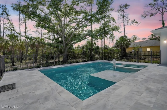 3390 12th Ave SE, Naples, FL 34117 - pool at dusk with a patio area, fence, and a pool with connected hot tub