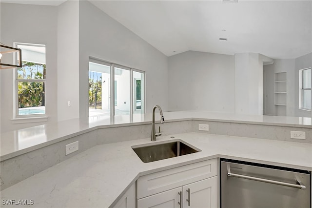 3390 12th Ave SE, Naples, FL 34117 - kitchen with stainless steel dishwasher, a sink, white cabinets, lofted ceiling, and light stone counters