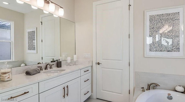 bathroom with a freestanding tub and vanity