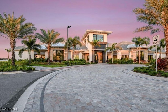 view of front of house featuring curved driveway