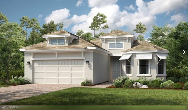 view of front of home featuring stucco siding, an attached garage, driveway, and a front yard