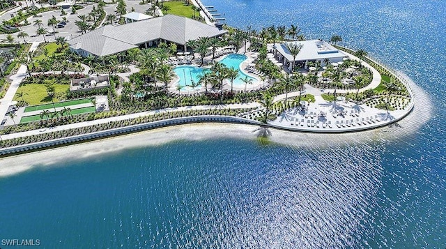 aerial view of a pool area and a large body of water