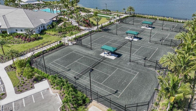 drone / aerial view of a pool and a large body of water