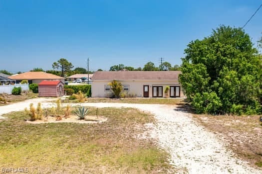 914 Albert Ave, Lehigh Acres, FL 33971 - ranch-style house with curved driveway