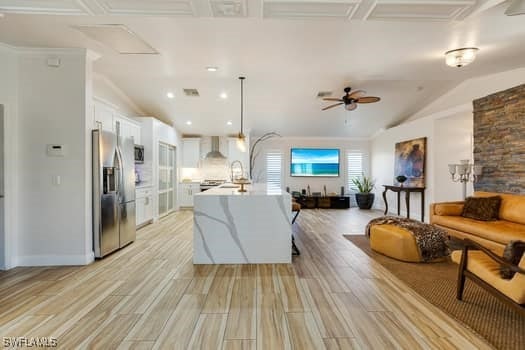 914 Albert Ave, Lehigh Acres, FL 33971 - living area featuring light wood-style floors, ceiling fan, vaulted ceiling, and recessed lighting