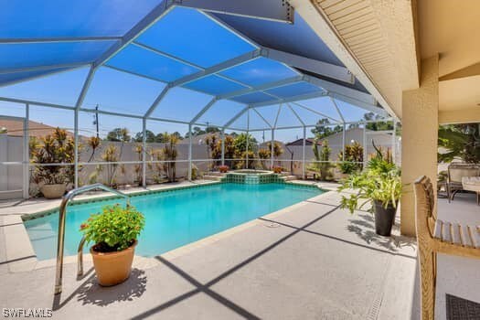 914 Albert Ave, Lehigh Acres, FL 33971 - view of pool featuring a patio, a pool with connected hot tub, and glass enclosure