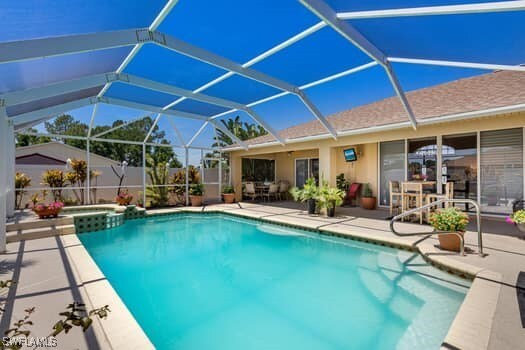 914 Albert Ave, Lehigh Acres, FL 33971 - view of pool with a patio area, a pool with connected hot tub, and a lanai