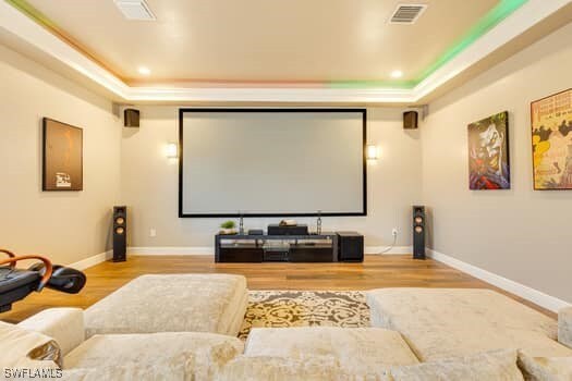 914 Albert Ave, Lehigh Acres, FL 33971 - home theater room with a raised ceiling, wood finished floors, and baseboards