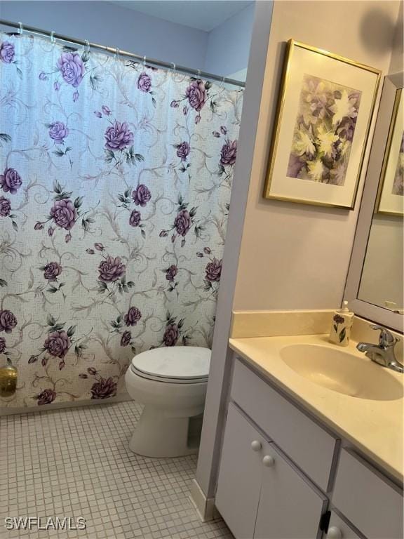 7731 Bocilla Ln Unit 9, Bokeelia, FL 33922 - full bath featuring toilet, vanity, tile patterned flooring, and curtained shower