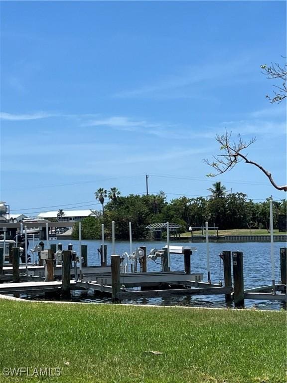 7731 Bocilla Ln Unit 9, Bokeelia, FL 33922 - dock with boat lift, a water view, and a yard