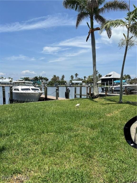 7731 Bocilla Ln Unit 9, Bokeelia, FL 33922 - view of green lawn with a dock