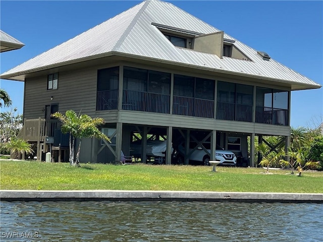 7731 Bocilla Ln Unit 9, Bokeelia, FL 33922 - back of property featuring a water view, a sunroom, and metal roof