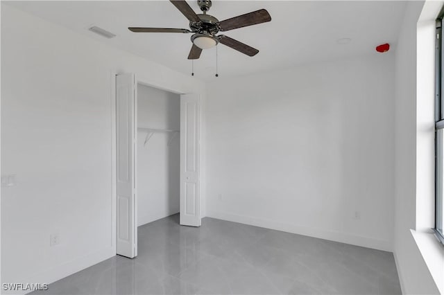 3604 Flora Ave N, Lehigh Acres, FL 33971 - unfurnished bedroom featuring a closet, baseboards, and a ceiling fan