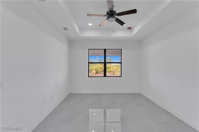 3604 Flora Ave N, Lehigh Acres, FL 33971 - unfurnished room with a tray ceiling, a ceiling fan, baseboards, light tile patterned floors, and recessed lighting