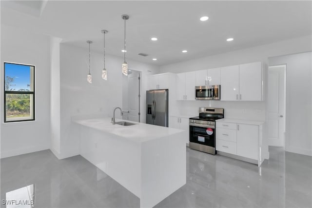 3107 33rd St W, Lehigh Acres, FL 33971 - kitchen with stainless steel appliances, a sink, white cabinets, light countertops, and recessed lighting