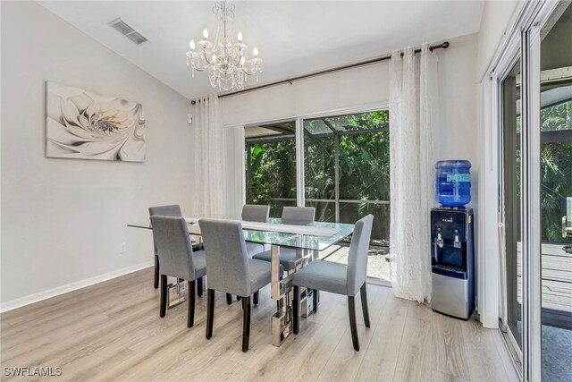 120 Heritage Way, Naples, FL 34110 - dining room featuring a chandelier, light wood-type flooring, healthy amount of natural light, baseboards, and lofted ceiling