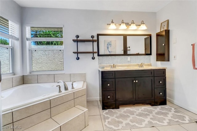 120 Heritage Way, Naples, FL 34110 - bathroom with baseboards, a bath, tile patterned flooring, and double vanity