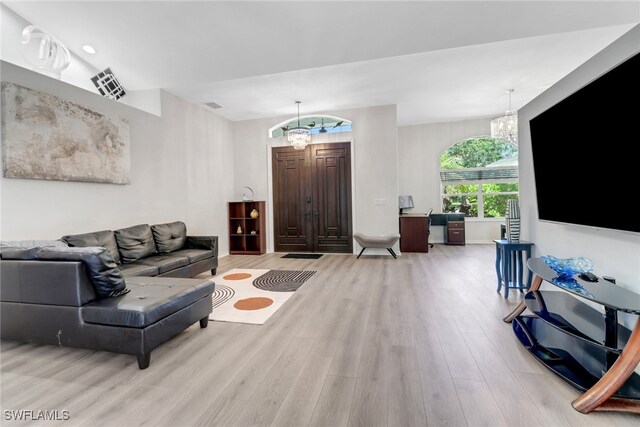 120 Heritage Way, Naples, FL 34110 - living room with light wood-type flooring and a chandelier
