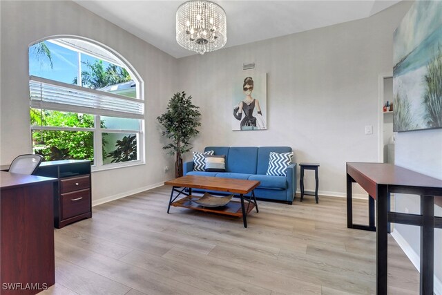 120 Heritage Way, Naples, FL 34110 - living area with a chandelier, light wood-style flooring, and baseboards