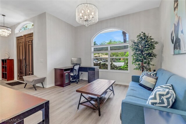 120 Heritage Way, Naples, FL 34110 - living area with a chandelier, light wood-style floors, a desk, and baseboards