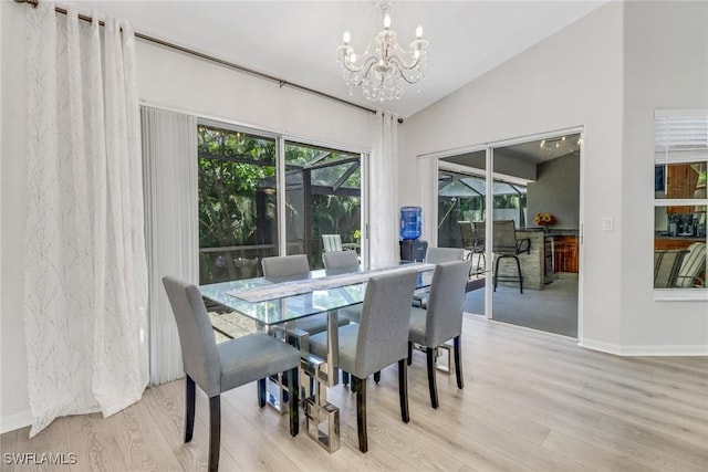 120 Heritage Way, Naples, FL 34110 - dining area featuring a chandelier, wood finished floors, baseboards, and vaulted ceiling