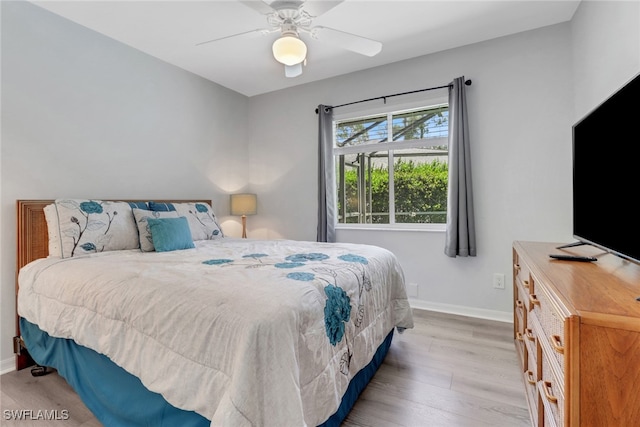 120 Heritage Way, Naples, FL 34110 - bedroom featuring baseboards, light wood-type flooring, and a ceiling fan