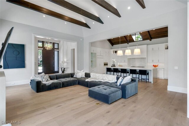 541 Whispering Pine Ct, Naples, FL 34103 - living room with beam ceiling, light wood-type flooring, baseboards, and high vaulted ceiling