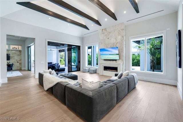 541 Whispering Pine Ct, Naples, FL 34103 - living area featuring a fireplace, beam ceiling, light wood-style floors, and baseboards