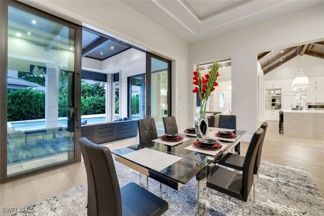 541 Whispering Pine Ct, Naples, FL 34103 - dining area with light wood-style flooring