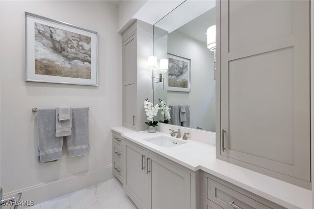 541 Whispering Pine Ct, Naples, FL 34103 - bathroom featuring marble finish floors and vanity